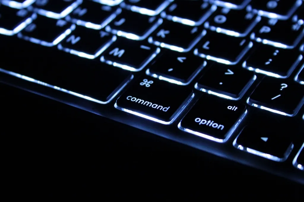 Backlit keyboard in the dark, close-up on the command and option keys