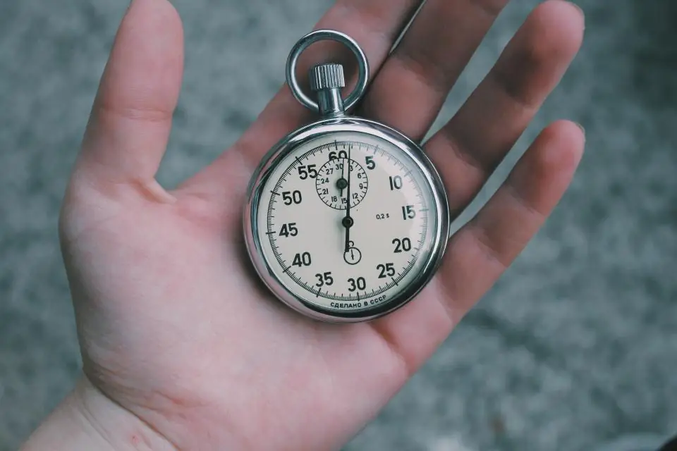 A stopwatch resting in the palm of a hand